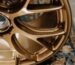 High-performance forged alloy wheel in bronze finish showcasing deep concave spokes and big brake caliper clearance (X-Factor).