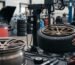 Professional technician mounting a low-profile tire onto a bronze custom forged alloy wheel using a tire changer machine, illustrating proper wheel-to-tire matching and plus-sizing.