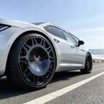 XL MONO SERIES-002 one-piece forged gloss black wheels on white luxury performance car cruising highway