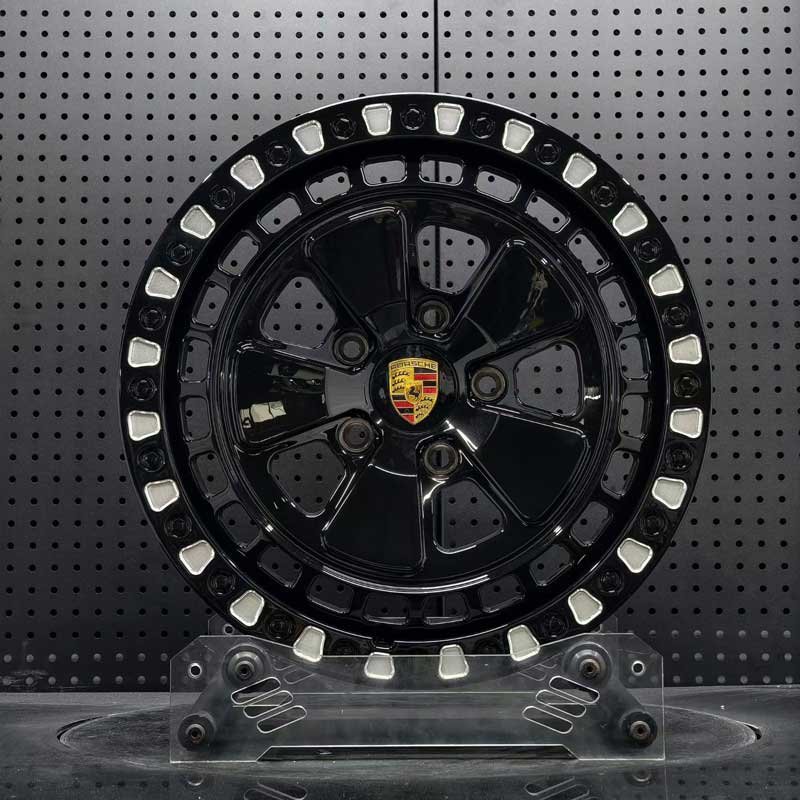 XL-OFF-ROAD-SERIES-004 Porsche Safari Forged Wheel - Front Face XL OFF-ROAD SERIES-004 gloss black Fuchs-style off-road forged wheel front face with Porsche crest center cap and milled beadlock pockets